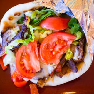Philly Cheesesteak Gyro. (Grilled Onions, Roasted Peppers, Lettuce, Tomatoes, Provolone, & Mayo)
