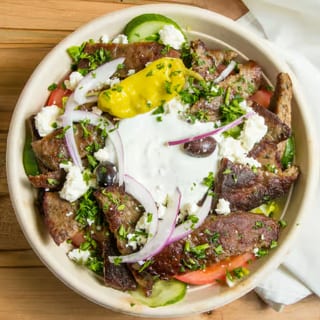 Greek Gyro Bowl. (Lettuce, Tomatoes, Onions, Cucumbers, Feta, Kalamata Olives, Pepperoncini Peppers, & Tzatziki Sauce)